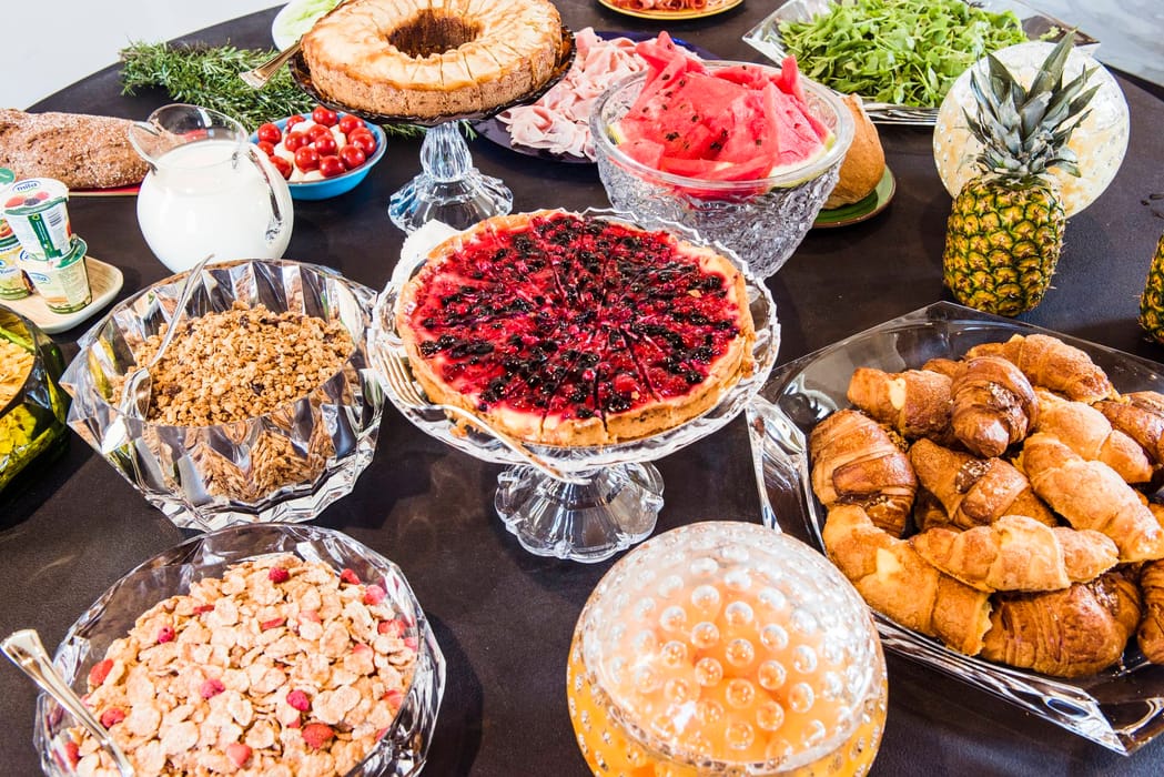 Table set for breakfast with pastries and fruit