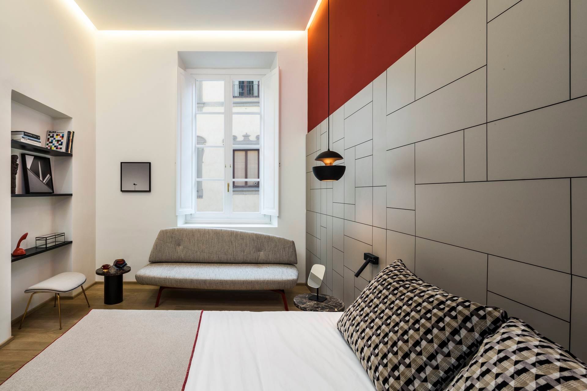 Detail of deluxe room with double bed and sofa