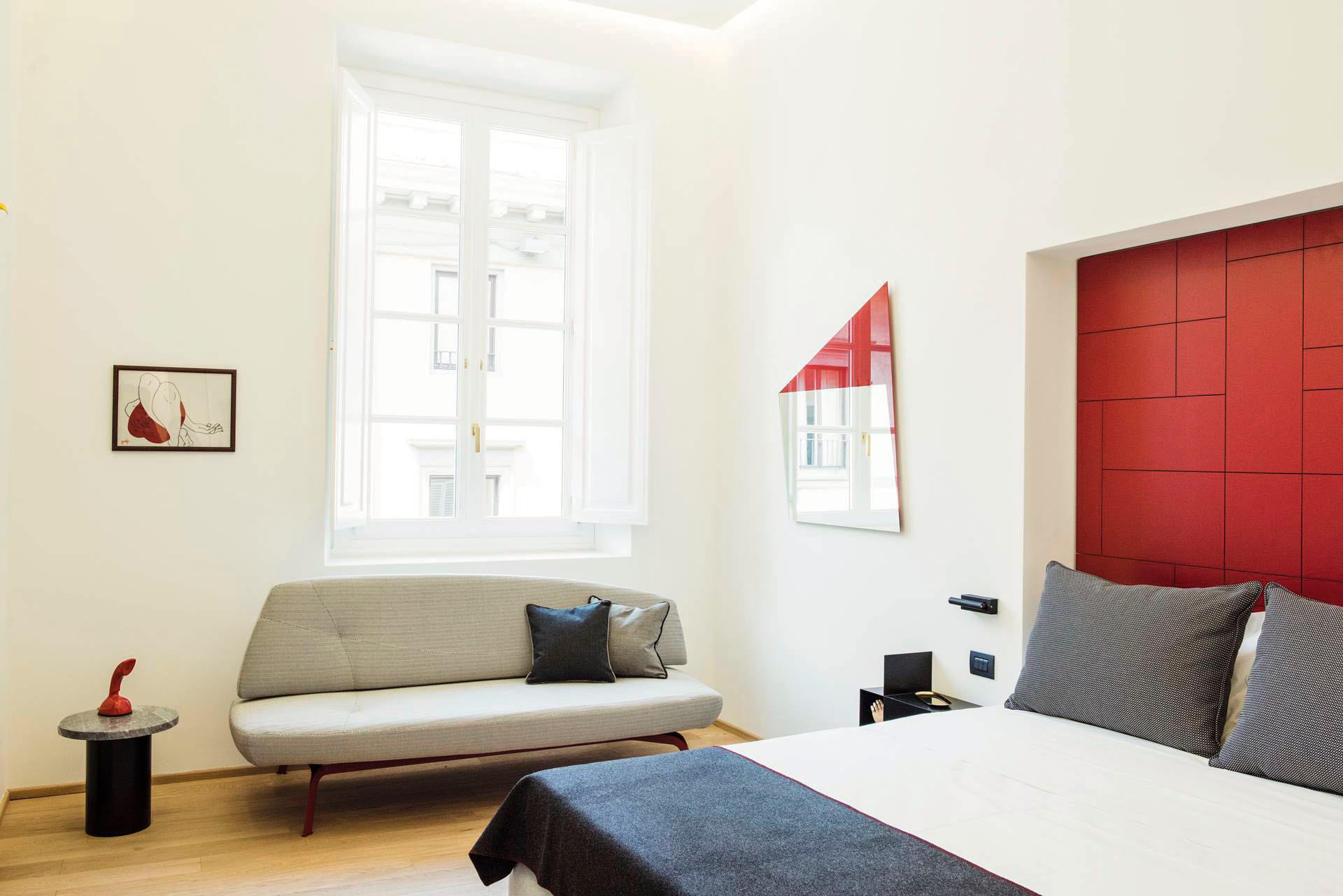 Deluxe room detail with double bed and sofa